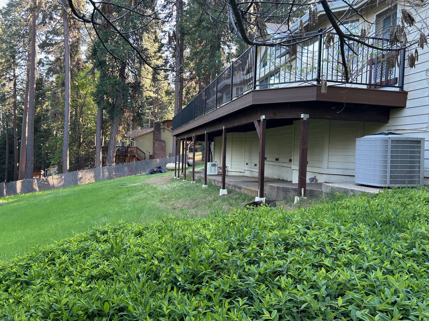 Rebuilt elevated composite deck with black steel railing, after