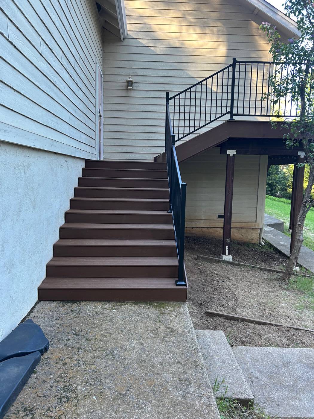 New composite stairs and landing with steel railing, after