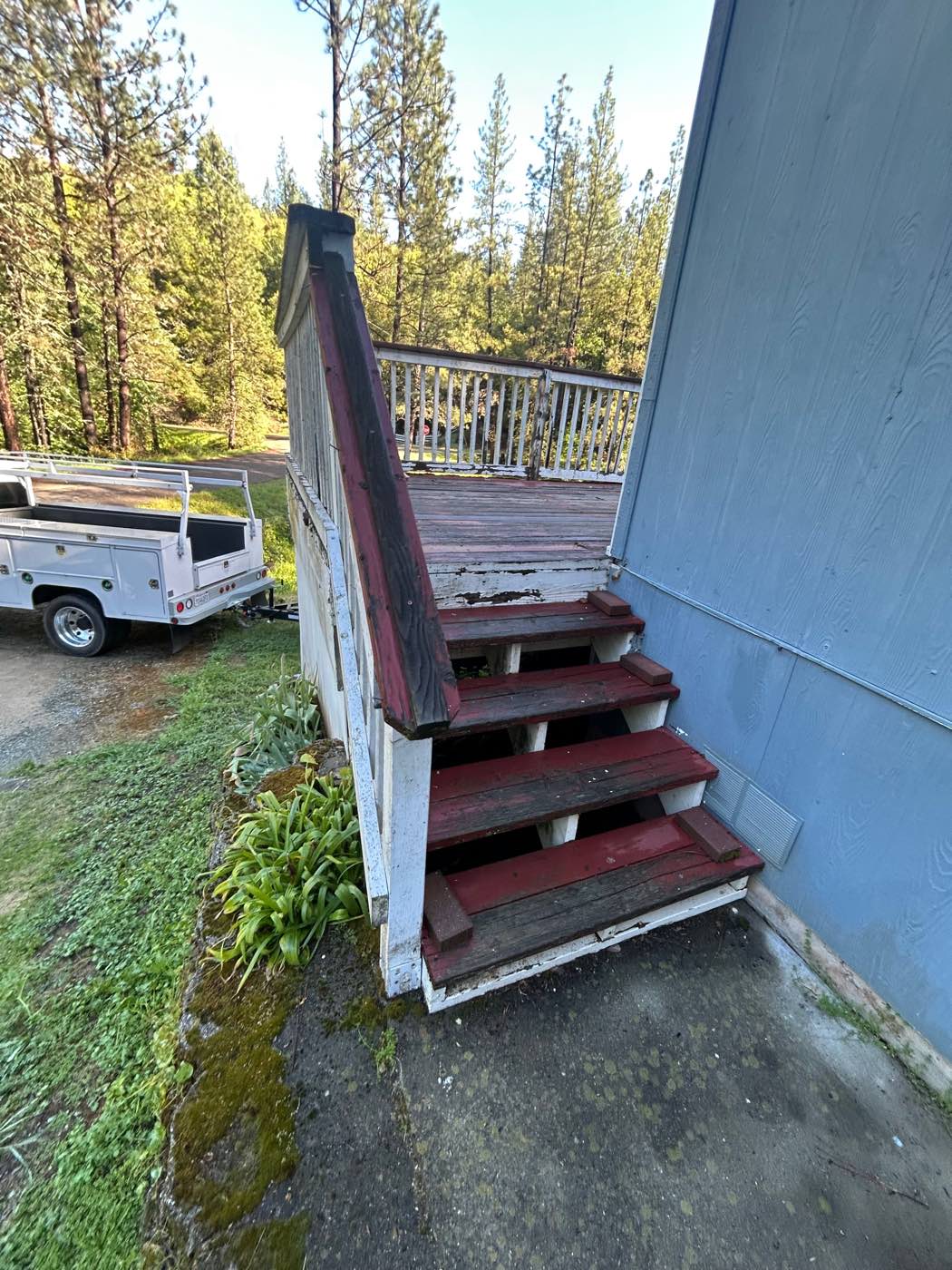 Worn wood deck and stairs with peeling paint, before