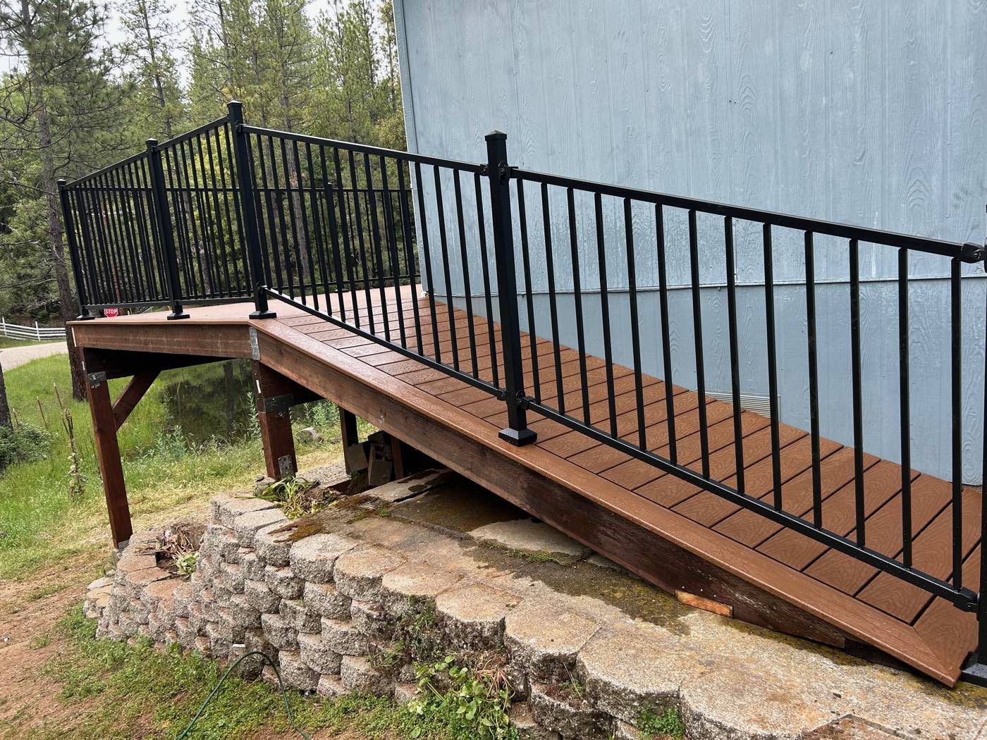 Composite accessible ramp and deck with steel railing