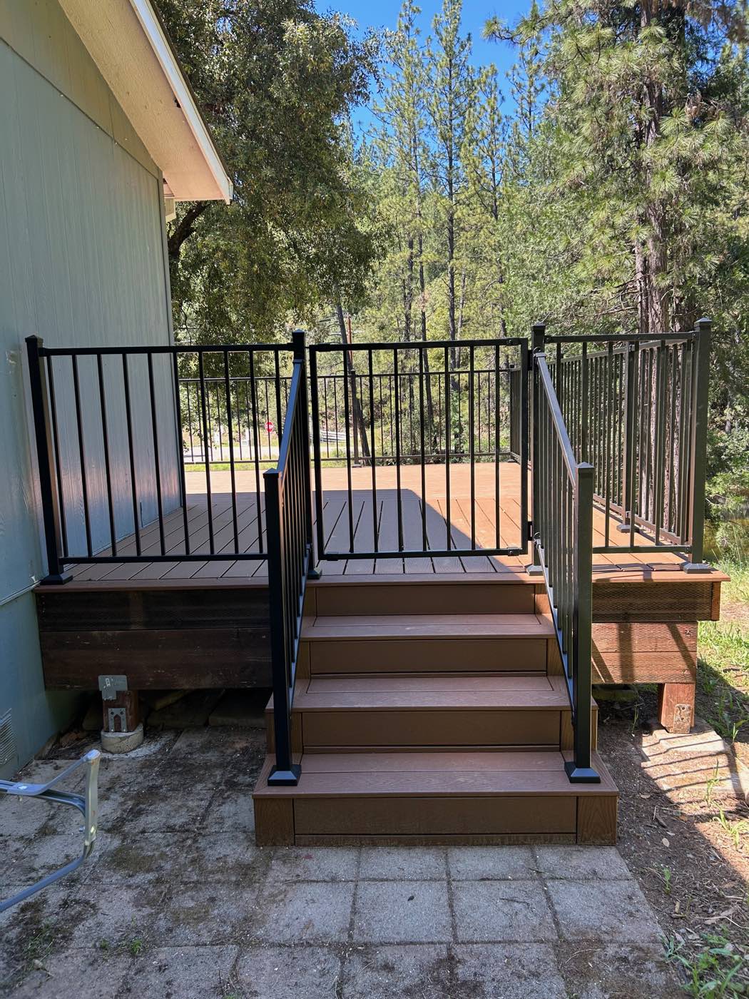 Composite deck with steps, landing and steel railing