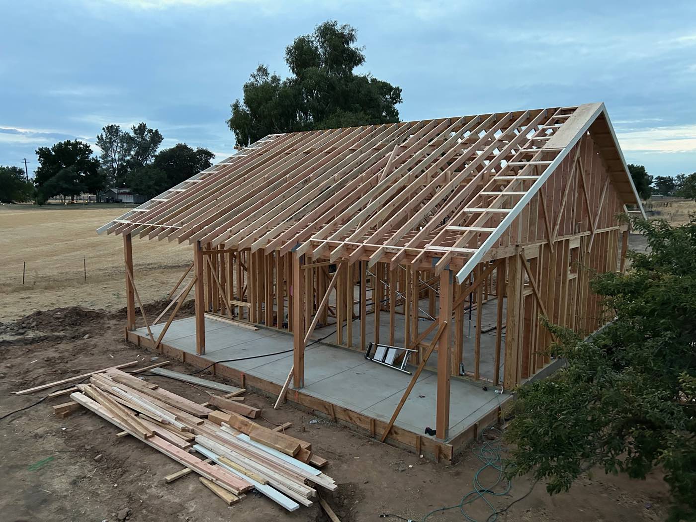 Wood-framed shop structure with rafters on a concrete slab