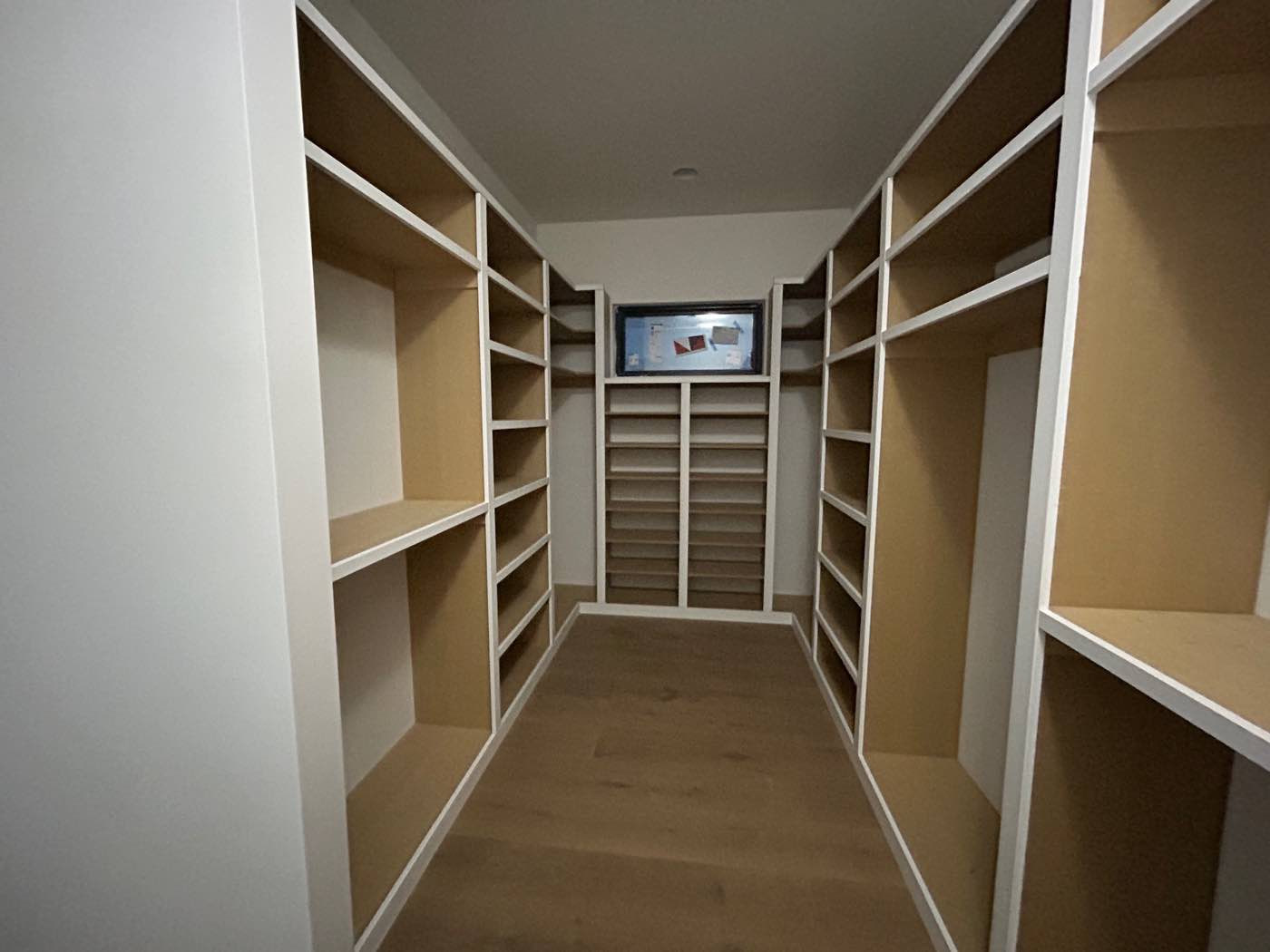 Custom walk-in closet with full-wall built-in shelving