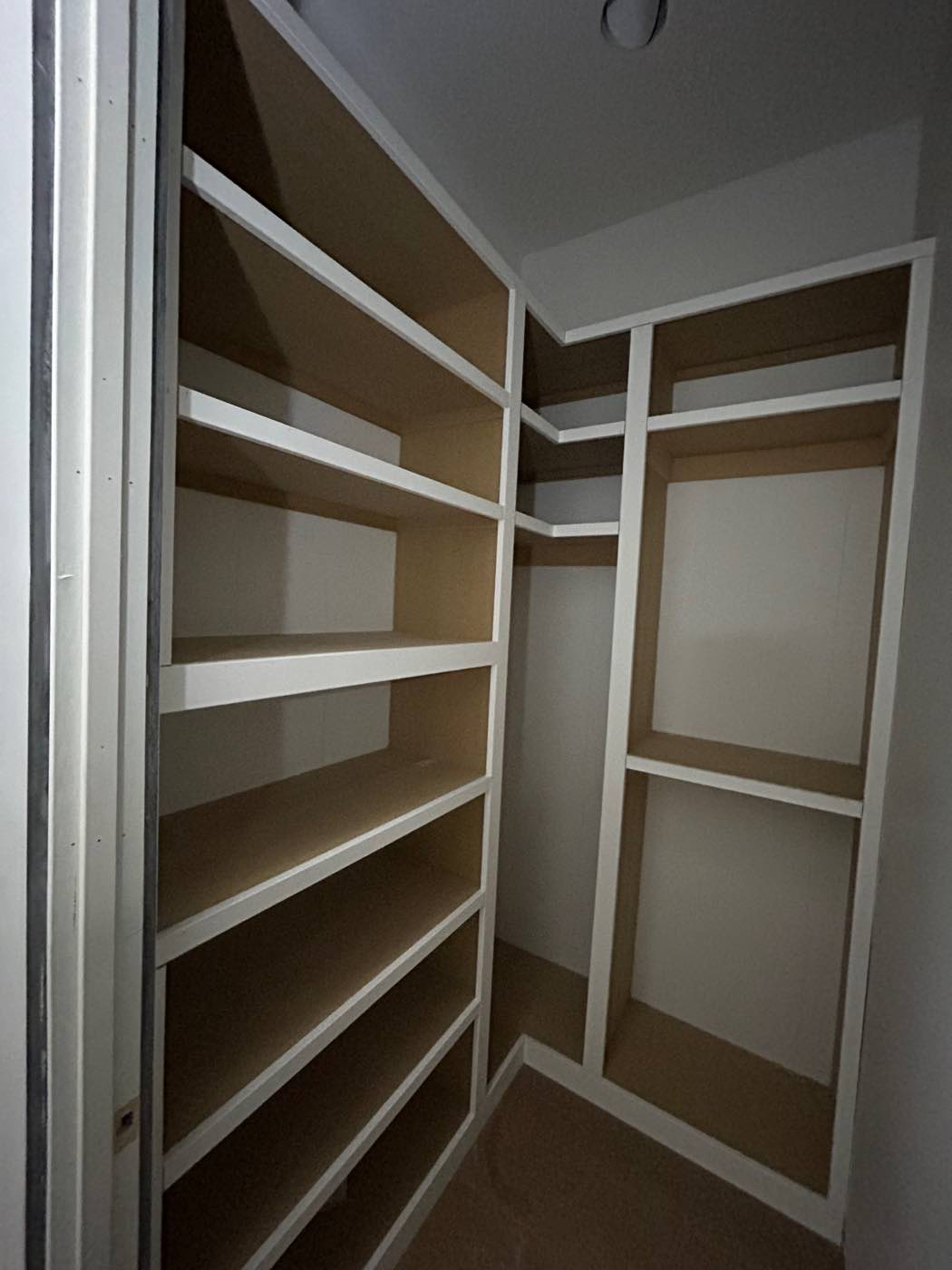 Custom corner shelving system built into a closet