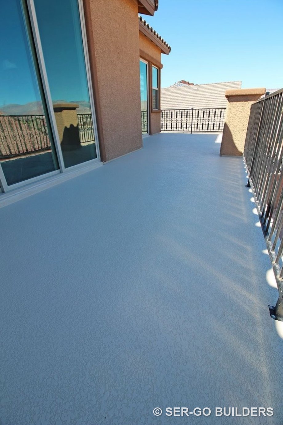 Second-story balcony with a light gray walkable waterproof deck coating